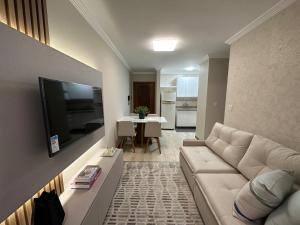 TV a/nebo společenská místnost v ubytování Apto super luxo beira mar Capão da Canoa