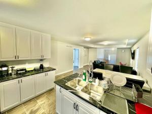 a kitchen with a sink and a counter top at Just 5 Minuts drive from Cobourg Beach in Cobourg