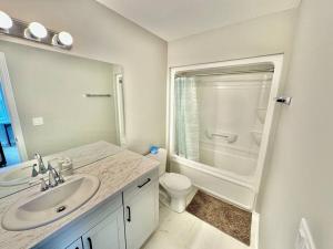 a bathroom with a sink and a shower and a toilet at Just 5 Minuts drive from Cobourg Beach in Cobourg