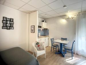 Pokój z łóżkiem, stołem i krzesłami w obiekcie Studio lumineux avec balcon à 50m des Thermes - Animaux acceptés, Wifi, options confort disponibles - FR-1-451-176 w mieście Lamalou-les-Bains +13 zdjęć