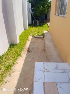 a sidewalk outside of a house with a window at AKs in Lusaka