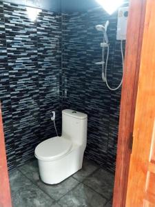 a bathroom with a toilet in a shower stall at Scorpion Wings Eco-Resort in Ban Na Nga
