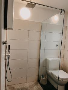 a bathroom with a toilet and a glass shower door at Wohnen im 3 Ländereck! Essen, Mülheim, Oberhausen. BSEG in Essen