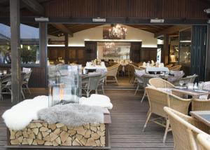 a restaurant with tables and chairs and a fireplace at Bischofshol in Hannover