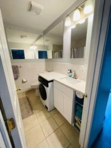 a bathroom with a sink and a washing machine at Newly renovated -2 Bedroom Condo in Boston