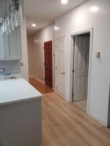 cocina con encimera blanca y pasillo con puerta en Newly renovated -2 Bedroom Condo, en Boston