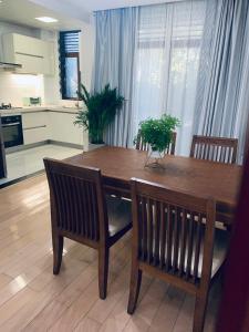a kitchen with a wooden table and two chairs at Gorgeous apartment with private backyard in Wuhan