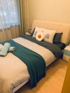 a bedroom with a bed with a stuffed animal on it at Gorgeous apartment with private backyard in Wuhan