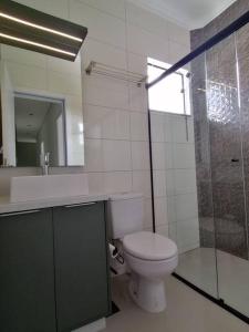a bathroom with a toilet and a sink and a shower at Confort Class GD II in Pomerode