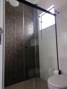 a bathroom with a glass shower and a toilet at Confort Class GD II in Pomerode