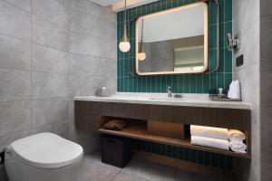 a bathroom with a sink and a mirror at Home2 Suites by Hilton Beijing West Station in Beijing