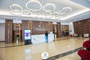 a man standing in the lobby of a building at Royal Serviced apartment Vinhomes Metropolis in Hanoi