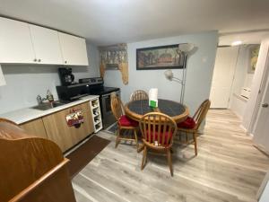 a kitchen with a table and chairs in a room at Nice 2bedroom Apt With Patio Included To Enjoy in West New York
