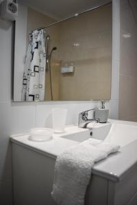 a bathroom with a sink and a mirror at Bella's Hideaway in Ponta Delgada