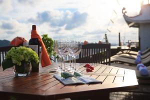 a table with wine glasses and a bottle of wine at Halong Bay Full Day Trip - 6 Hours Route in Ha Long