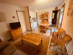 a living room with a couch and a table at Appartement La Clusaz, 2 pièces, 6 personnes - FR-1-459-219 in La Clusaz