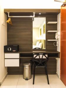 a dressing room with a desk and a mirror at Louis Hotel in Taiping