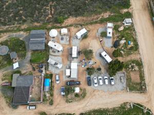 an aerial view of a farm with vehicles parked at Ecovino Valle de Guadalupe in Valle de Guadalupe