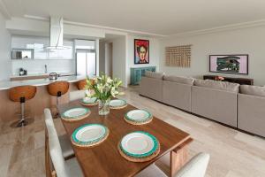 een woonkamer met een tafel en een bank bij Luxurious Ocean View Apartment in Cabo San Lucas