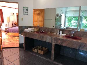 a bathroom with two sinks and a large mirror at Argonauta Boracay Apartment Suites and Villas in Boracay