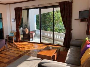 a living room with a couch and a large window at Argonauta Boracay Apartment Suites and Villas in Boracay