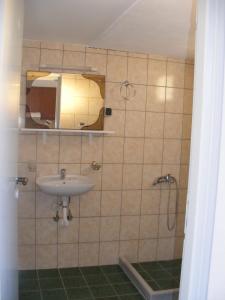 a bathroom with a sink and a mirror at PanoramaKamil in Kamilari