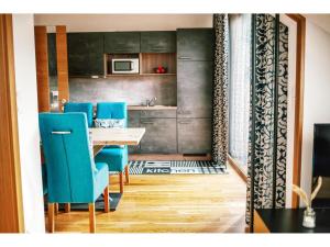 a dining room with a table and blue chairs at Apartment in Hohentauern with sauna in Hohentauern