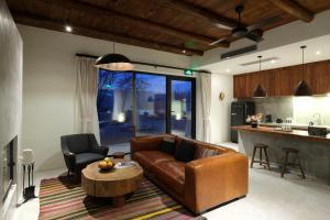 a living room with a couch and a table and a kitchen at South Zhongwei Resort in Zhongwei