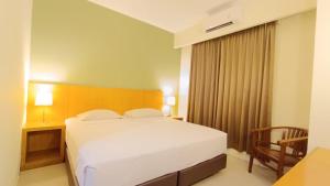 Voodi või voodid majutusasutuse Hotel Wisata toas