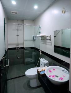 a bathroom with a shower and a toilet and a sink at TamCoc Golden Shine Homestay in Ninh Binh +22 photos