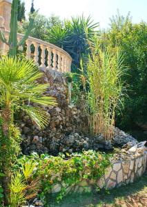 a garden with a stone wall and some plants at Villa Javea in Jávea
