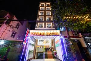 a building with a sign that reads vienna hotel at Vivian Airport Hotel Saigon in Ho Chi Minh City