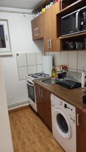 a kitchen with a stove and a washing machine at A&M in Târgu-Mureş