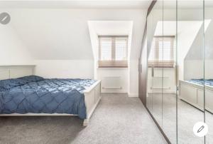 a bedroom with a bed and two windows at Dartford LakeView Terrace in Kent