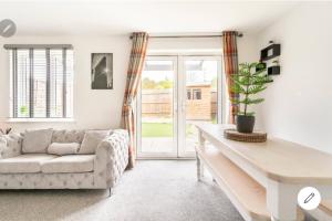 a living room with a couch and a table at Dartford LakeView Terrace in Kent