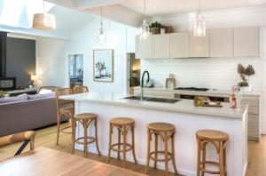 a kitchen and living room with a counter and stools at Luxury Resort Style in Olinda - Greenways in Olinda