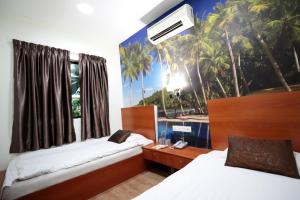Postel nebo postele na pokoji v ubytování Rain Forest Hotel