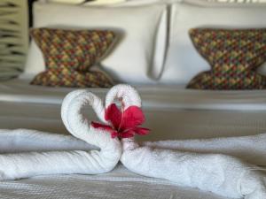 a towel folded into a swan on a bed at Mahajab Homestay SIARGAO in General Luna