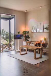 a living room with a bench and a table at Jeju Geumeum in Seogwipo