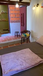 a room with a bed and a chair and a brick wall at Daughter and son in Jinhu