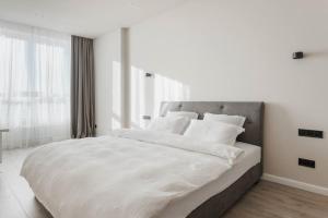 Posteľ alebo postele v izbe v ubytovaní Noviy Bereg Design Apartment