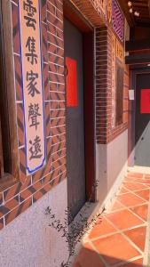 eine Tür zu einem Gebäude mit Schildern darauf in der Unterkunft Daughter and son in Jinhu