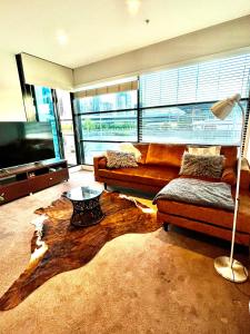 a living room with a couch and a coffee table at Luxurious Apartment in the heart of Docklands in Melbourne