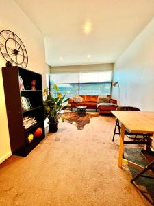 a living room with a couch and a table at Luxurious Apartment in the heart of Docklands in Melbourne