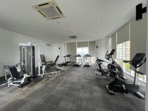 a gym with several treadmills and elliptical machines at Encorp Marina, 2 Bedroom, 6pax, Same Floor with Indoor Infinity Pool in Nusajaya