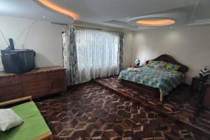 Ένα ή περισσότερα κρεβάτια σε δωμάτιο στο Casa de campo centro Cotacachi.
