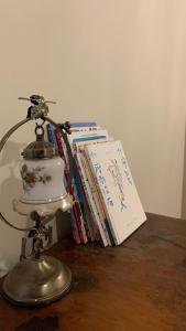 a lamp sitting on a table next to a stack of books at Daughter and son in Jinhu