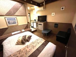 Habitación de hotel con cama y TV en Hotel Crystal 大人専用, en Tokio