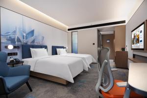 Voodi või voodid majutusasutuse Hampton by Hilton Guangzhou Xintang toas