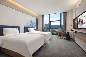 Postel nebo postele na pokoji v ubytování Hampton by Hilton Guangzhou Xintang + 37 fotografií